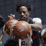 DeMar DeRozan signs a fan's basketball during a training camp for USA basketball, Thursday, July 26, 2018, in Las Vegas. (AP Photo/John Locher)
