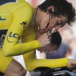 Britain's Geraint Thomas, wearing the overall leader's yellow jersey, eats as he warms up prior to the twentieth stage of the Tour de France cycling race, an individual time trial over 31 kilometers (19.3 miles)with start in Saint-Pee-sur-Nivelle and finish in Espelette, France, Saturday July 28, 2018. (AP Photo/Peter Dejong)