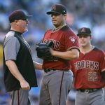 Arizona Diamondbacks pitching coach Mike Butcher, left, confers with relief pitcher Jorge De La Rosa, who was called for a balk in the second inning of a baseball game against the Colorado Rockies on Wednesday, July 11, 2018, in Denver. (AP Photo/David Zalubowski)