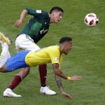 Brazil's Neymar, bottom, challenges for the ball with Mexico's Edson Alvarez during the round of 16 match between Brazil and Mexico at the 2018 soccer World Cup in the Samara Arena, in Samara, Russia, Monday, July 2, 2018. (AP Photo/Sergei Grits)