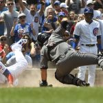 Chicago Cubs' Willson Contreras, left, slides safely past Arizona Diamondbacks catcher Alex Avila (5) during the second inning of a baseball game, Thursday, July 26, 2018, in Chicago. (AP Photo/David Banks)