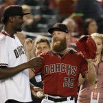 Phoenix Suns NBA basketball first pick in the 2018 draft Deandre Ayton, left, talks with Arizona Diamondbacks relief pitcher Archie Bradley (25) prior to a baseball game against the San Francisco Giants, Sunday, July 1, 2018, in Phoenix. (AP Photo/Ross D. Franklin)