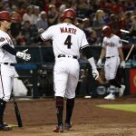 Arizona Diamondbacks' Ketel Marte (4) celebrates with John Ryan Murphy, left, after Marte scored against the San Diego Padres during the second inning of a baseball game Thursday, July 5, 2018, in Phoenix. (AP Photo/Ross D. Franklin)