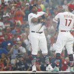 Milwaukee Brewers Jesús Aguilar, left, and Philadelphia Phillies Rhys Hoskins (17) face off before the MLB Home Run Derby, at Nationals Park, Monday, July 16, 2018 in Washington. The 89th MLB baseball All-Star Game will be played Tuesday. (AP Photo/Patrick Semansky)