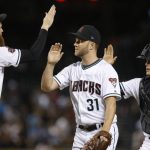 Arizona Diamondbacks relief pitcher Brad Boxberger (31) celebrates with Archie Bradley (25) and catcher John Ryan Murphy at the end of the team's 3-1 win in a baseball game against the San Diego Padres on Friday, July 6, 2018, in Phoenix. (AP Photo/Ross D. Franklin)