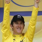 Britain's Geraint Thomas, wearing the overall leader's yellow jersey, flashes two thumbs up on the podium after the twentieth stage of the Tour de France cycling race, an individual time trial over 31 kilometers (19.3 miles)with start in Saint-Pee-sur-Nivelle and finish in Espelette, France, Saturday July 28, 2018. (AP Photo/Christophe Ena )