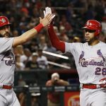St. Louis Cardinals' Tommy Pham (28) and Matt Carpenter, left, celebrate their runs scored against the Arizona Diamondbacks during the first inning of a baseball game Monday, July 2, 2018, in Phoenix. (AP Photo/Ross D. Franklin)
