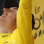 Britain's Geraint Thomas, wearing the overall leader's yellow jersey, celebrates on the podium after the twentieth stage of the Tour de France cycling race, an individual time trial over 31 kilometers (19.3 miles)with start in Saint-Pee-sur-Nivelle and finish in Espelette, France, Saturday July 28, 2018. (AP Photo/Peter Dejong)
