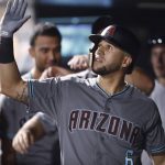 Arizona Diamondbacks' David Peralta is congratulated as he returns to the dugout after hitting a three-run home run off Colorado Rockies relief pitcher Jake McGee during the seventh inning of a baseball game Tuesday, July 10, 2018, in Denver. (AP Photo/David Zalubowski)