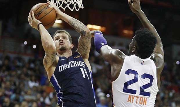Dallas Mavericks' Josh Adams, left, shoots around Phoenix Suns' Deandre Ayton during the first half...