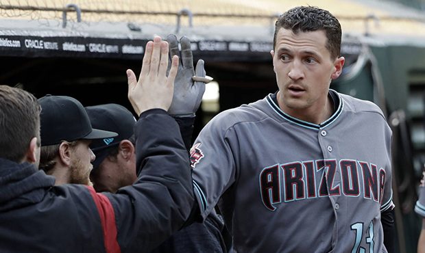 Arizona Diamondbacks' Nick Ahmed receives a high-five in the dugout after hitting a solo home run a...