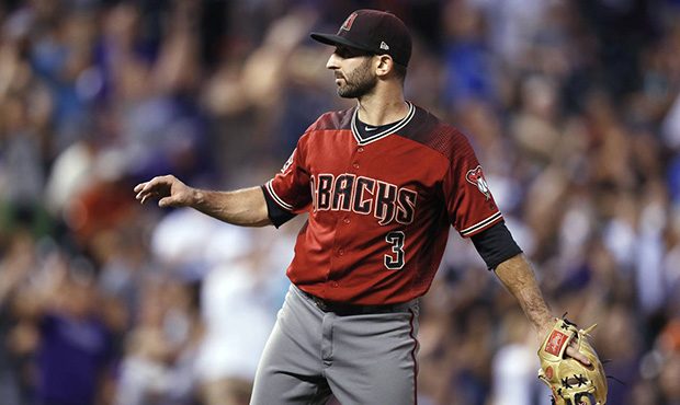 Arizona Diamondbacks infielder-turned-relief-pitcher Daniel Descalso calls for a new ball after giv...