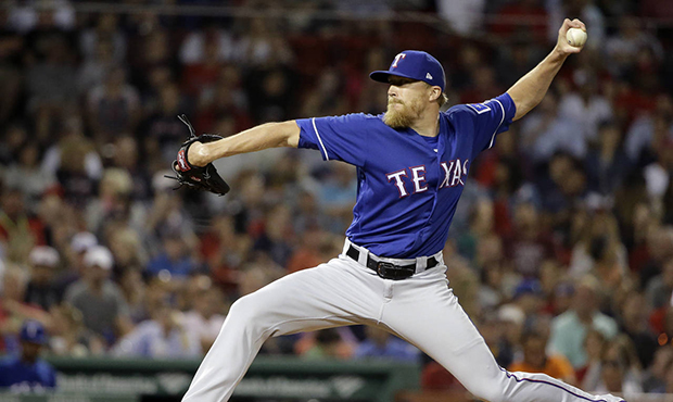 Texas Rangers' Jake Diekman winds up for a pitch to a Boston Red Sox batter during the seventh inni...