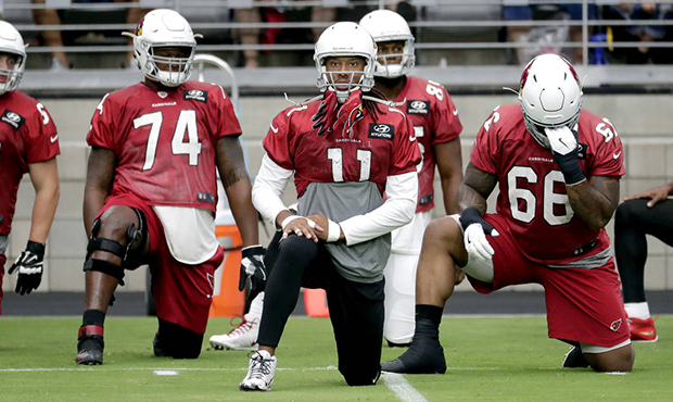 Arizona Cardinals wide receiver Larry Fitzgerald (11) stretches with teammates during the first day...