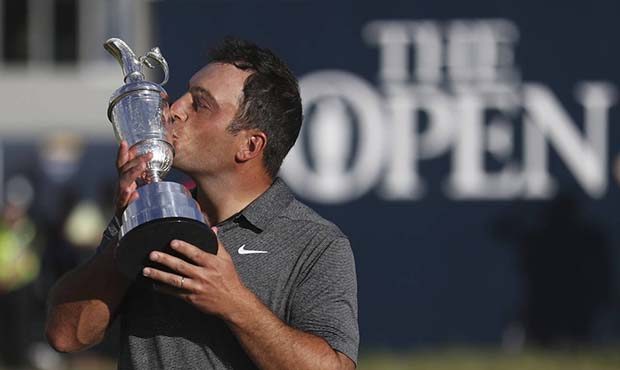 Francesco Molinari of Italy kisses the trophy after winning the British Open Golf Championship in C...