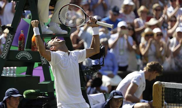Serbia's Novak Djokovic celebrates winning the men's singles final match against Kevin Anderson of ...