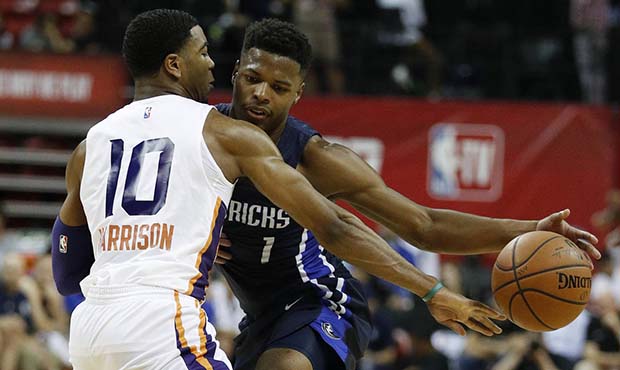 Dallas Mavericks' Dennis Smith Jr., right, drives into Phoenix Suns' Shaquille Harrison during the ...