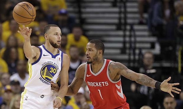 Golden State Warriors guard Stephen Curry (30) passes the ball as he is defended by Houston Rockets...
