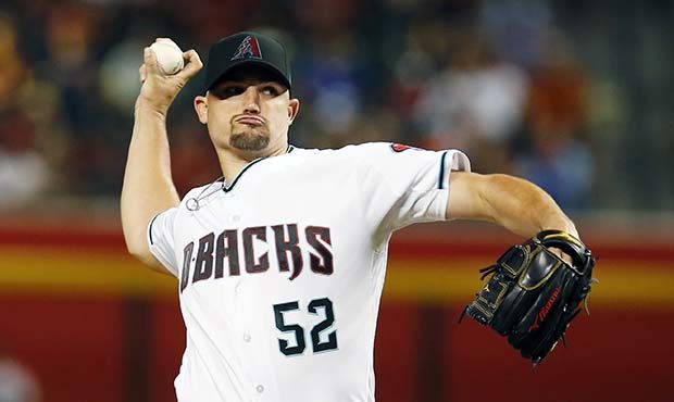 Arizona Diamondbacks starting pitcher Zack Godley throws during the first inning of the team's base...