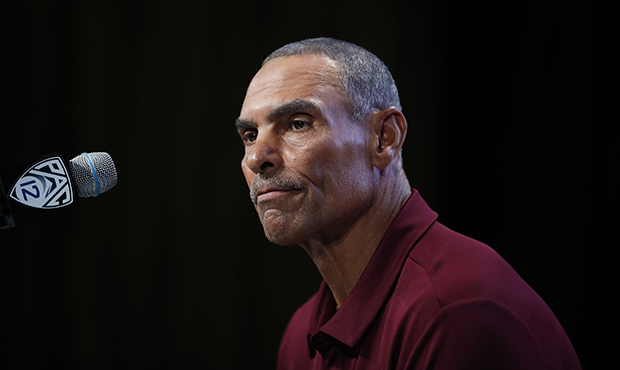 Arizona State head coach Herm Edwards pauses while speaking at the Pac-12 Conference NCAA college f...