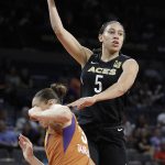 Las Vegas Aces forward Dearica Hamby, right, passes the ball as Phoenix Mercury guard Diana Taurasi defends during the second half of a WNBA basketball game, Wednesday, Aug. 1, 2018, in Las Vegas. (AP Photo/John Locher)