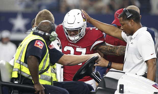 Arizona Cardinals running back D.J. Foster (37) is helped off of the field during the first half of...