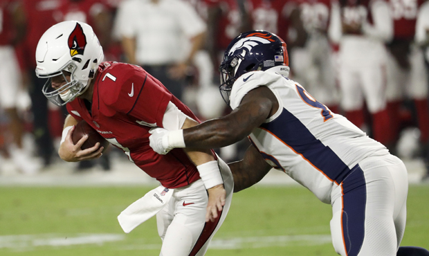 Arizona Cardinals quarterback Mike Glennon breaks away from Denver Broncos defensive end DeShawn Wi...