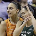 Phoenix Mercury's Diana Taurasi, left, briefly embraces Seattle Storm's Sue Bird as Bird calls a timeout moments after Taurasi connected on a 3-point shot with seconds left in the second half in a WNBA basketball playoff semifinal, Tuesday, Aug. 28, 2018, in Seattle. The shot sent the game into overtime and the Storm won 91-87. (AP Photo/Elaine Thompson)