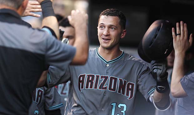 Arizona Diamondbacks' Nick Ahmed is congratulated as he returns to the dugout after hitting a solo ...
