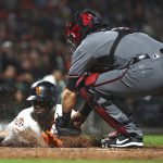 Arizona Diamondbacks catcher Alex Avila, right, tags out San Francisco Giants' Andrew McCutchen at home plate in the sixth inning of a baseball game, Monday, Aug. 27, 2018, in San Francisco. (AP Photo/Ben Margot)
