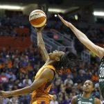 Phoenix Mercury guard Yvonne Turner, left, gets off a shot in front of Seattle Storm forward Breanna Stewart (30) as Storm guard Jewell Loyd, rear, watches during the second half of Game 3 of a WNBA basketball playoffs semifinal Friday, Aug. 31, 2018, in Phoenix. The Mercury defeated the Storm 86-66. (AP Photo/Ross D. Franklin)