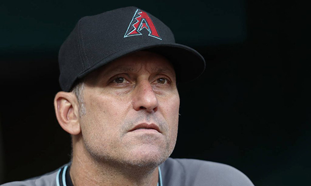 Arizona Diamondbacks manager Torey Lovullo works in the dugout in the fourth inning of a baseball g...