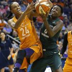 Phoenix Mercury forward DeWanna Bonner (24) works agianst Seattle Storm forward Natasha Howard, right, for a rebound during the first half of Game 3 of a WNBA basketball playoffs semifinal Friday, Aug. 31, 2018, in Phoenix. (AP Photo/Ross D. Franklin)