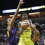 Seattle Storm's Natasha Howard, center, drives between Phoenix Mercury's Angel Robinson, left, and DeWanna Bonner in the first half of a WNBA basketball playoff semifinal Sunday, Aug. 26, 2018, in Seattle. (AP Photo/Elaine Thompson)