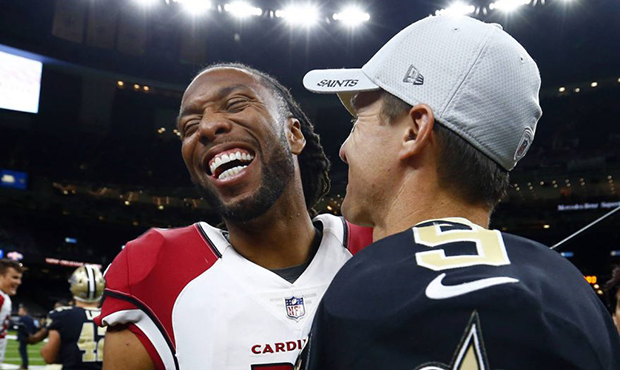 Arizona Cardinals wide receiver Larry Fitzgerald laughs with New Orleans Saints quarterback Drew Br...