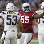 Arizona Cardinals defensive end Chandler Jones (55) celebrates a defensive stop as Los Angeles Chargers center Mike Pouncey (53) looks on during the first half of a preseason NFL football game, Saturday, Aug. 11, 2018, in Glendale, Ariz. (AP Photo/Ross D. Franklin)
