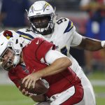 Los Angeles Chargers defensive tackle Corey Liuget (94) grabs the face mask of Arizona Cardinals quarterback Josh Rosen (3) for a 15-yard penalty during the first half of a preseason NFL football game, Saturday, Aug. 11, 2018, in Glendale, Ariz. (AP Photo/Ross D. Franklin)