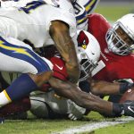 Arizona Cardinals running back Chase Edmonds stretches the football across the goal line for a touchdown as Los Angeles Chargers linebacker Kyzir White, left, defends during the first half of an preseason NFL football game, Saturday, Aug. 11, 2018, in Glendale, Ariz. (AP Photo/Ross D. Franklin)