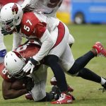Arizona Cardinals linebacker Josh Bynes (57) tackles tight end Gabe Holmes, bottom, during an NFL football practice Saturday, Aug. 4, 2018, in Glendale, Ariz. (AP Photo/Ross D. Franklin)