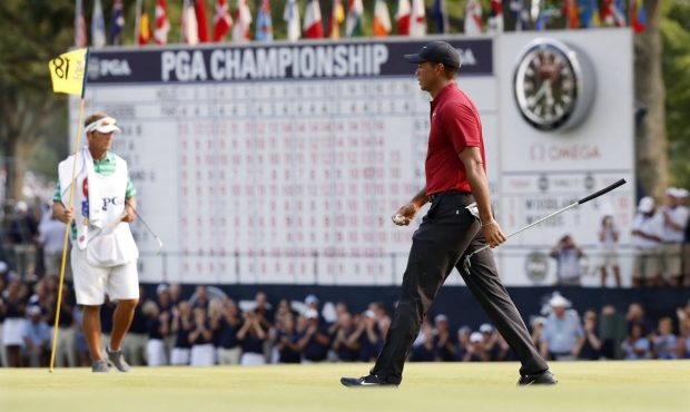 Tiger Woods walks off the 18th green after making a birdie during the final round of the PGA Champi...