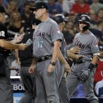 Arizona Diamondbacks' Nick Ahmed, right, is held back by third base coach Tony Perezchica as manager Torey Lovullo (17) speaks with umpire James Hoye, left, during the third inning of the team's baseball game against the San Diego Padres on Friday, Aug. 17, 2018, in San Diego. Ahmed was ejected by Hoye for arguing after striking out during his at-bat. (AP Photo/Gregory Bull)