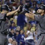 Arizona Diamondbacks' David Peralta, right, celebrates his three-run home run with A.J. Pollock during the fifth inning of a baseball game against the Los Angeles Dodgers on Thursday, Aug. 30, 2018, in Los Angeles. (AP Photo/Marcio Jose Sanchez)