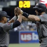 Arizona Diamondbacks' Paul Goldschmidt, right, is greeted by Eduardo Escobar after hitting a two-run home run during the first inning of a baseball game against the San Diego Padres on Friday, Aug. 17, 2018, in San Diego. (AP Photo/Gregory Bull)