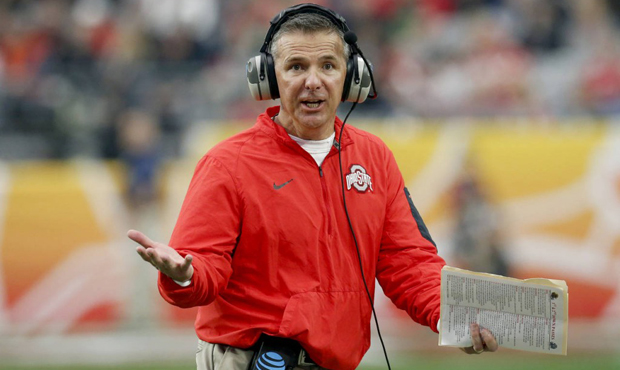 Ohio State head coach Urban Meyer makes a call during the first half of the Fiesta Bowl NCAA Colleg...