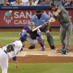 Arizona Diamondbacks' Paul Goldschmidt, right, hits a two-run home run as Los Angeles Dodgers starting pitcher Hyun-Jin Ryu, left, watches with catcher Yasmani Grandal, second from left, and home plate umpire Tom Hallion during the first inning of a baseball game Friday, Aug. 31, 2018, in Los Angeles. (AP Photo/Mark J. Terrill)