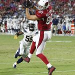 Arizona Cardinals tight end Bryce Williams (80) scores a touchdown as Los Angeles Chargers linebacker D'Juan Hines (59) pursues during the second half of a preseason NFL football game, Saturday, Aug. 11, 2018, in Glendale, Ariz. (AP Photo/Ross D. Franklin)