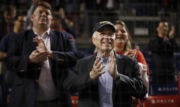 Sen. John McCain, R-Ariz., applauds during the break in the seventh inning of a baseball game betwe...