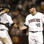Arizona Diamondbacks pitcher Andrew Chafin (40) celebrates with Jeff Mathis after defeating the San Francisco Giants in a baseball game, Saturday, Aug. 4, 2018, in Phoenix. (AP Photo/Rick Scuteri)