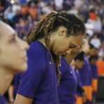 Phoenix Mercury guard Diana Taurasi, left, and center Brittney Griner, right, join teammates in a moment of silence for the late Arizona Republican Sen. John McCain, prior to Game 3 of a WNBA basketball playoffs semifinal against the Seattle Storm on Friday, Aug. 31, 2018, in Phoenix. The Mercury defeated the Storm 86-66. (AP Photo/Ross D. Franklin)