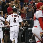 Arizona Diamondbacks' David Peralta (6) celebrates his two-run home run with Eduardo Escobar (14) as Los Angeles Angels catcher Rene Rivera, right, pauses at home plate during the seventh inning of a baseball game Wednesday, Aug. 22, 2018, in Phoenix. The Diamondbacks defeated the Angels 5-1. (AP Photo/Ross D. Franklin)